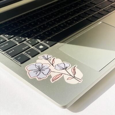 A decorative flower sticker on a laptop, showcasing a blend of technology and floral design.