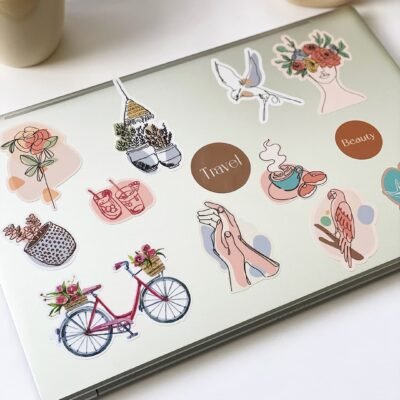A laptop decorated with multiple stickers, each displaying unique and vibrant design.