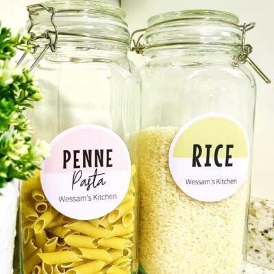 Two glass jars with metal clasps are placed on a countertop. One is labeled 