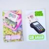 Two colorful cards: left shows a hand inserting cash into a pink money counter with bills, labeled "Eid Saeed"; right features "Cash Only!" and a card reader.