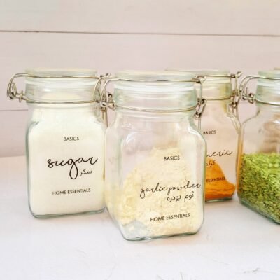 Four sealed glass jars labeled 