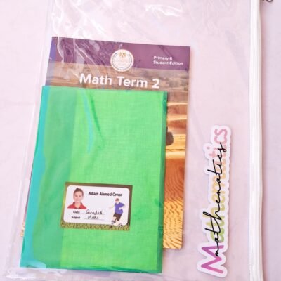 Clear school file holding a green notebook, “Math Term 2” Primary 6 textbook, name label, and colorful “Mathematics” sticker.