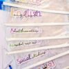 Stacked transparent files labeled Science, English, Mathematics, Islamic Studies, Social Studies, and Arabic in colorful lettering.